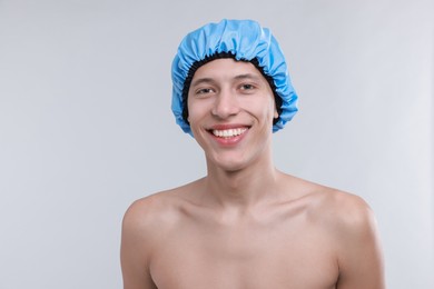 Photo of Man in shower cap on light grey background