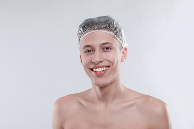 Photo of Man in shower cap on light grey background