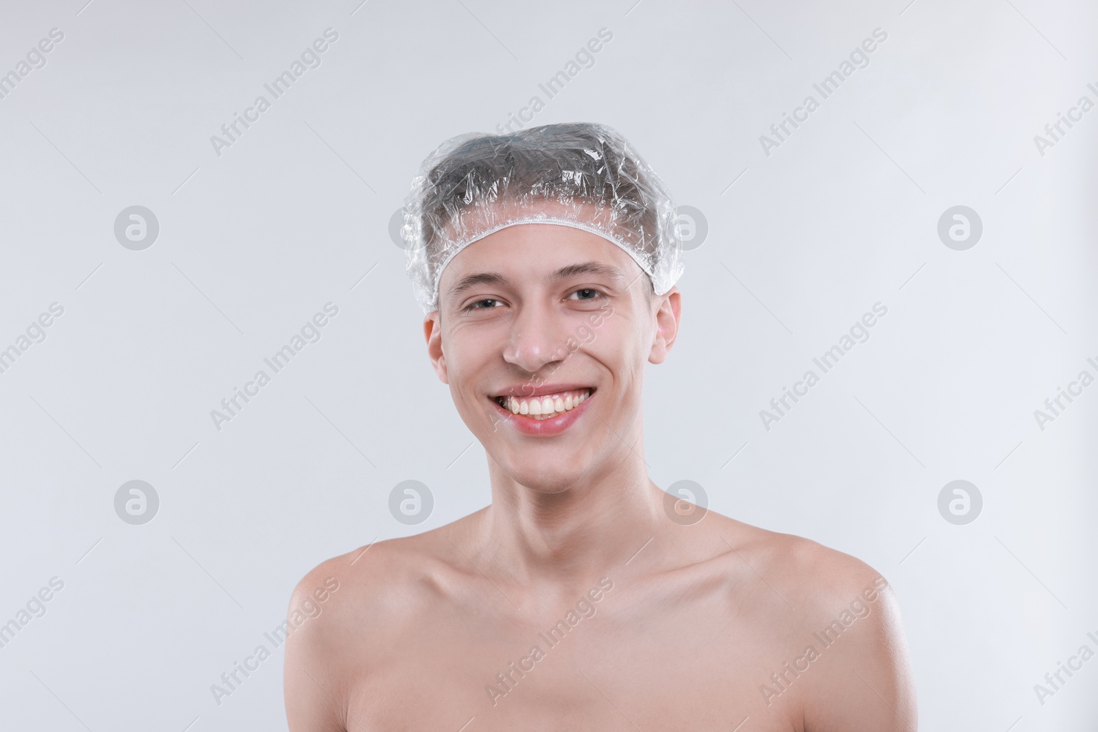 Photo of Man in shower cap on light grey background