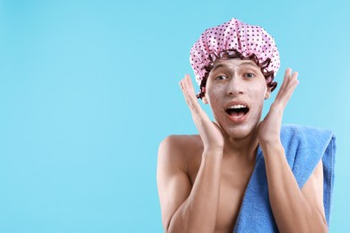 Photo of Man in shower cap with cream on his face against light blue background, space for text