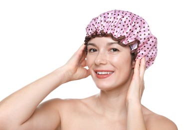 Woman wearing pink shower cap on white background