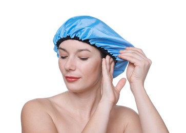 Woman wearing blue shower cap on white background