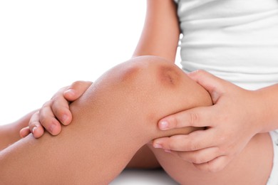 Photo of Child with bruise on leg against white background, closeup