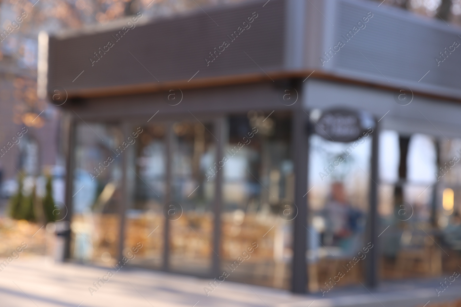 Photo of Stylish restaurant on city street, blurred view