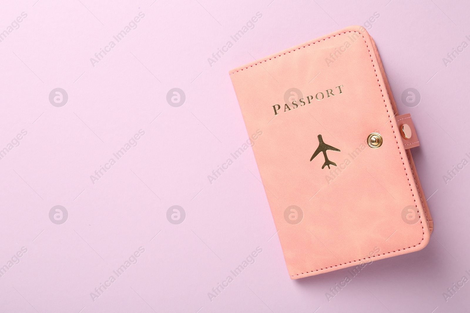 Photo of Passport in pink cover on violet background, top view. Space for text