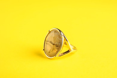 Beautiful bijouterie. Elegant ring on yellow background