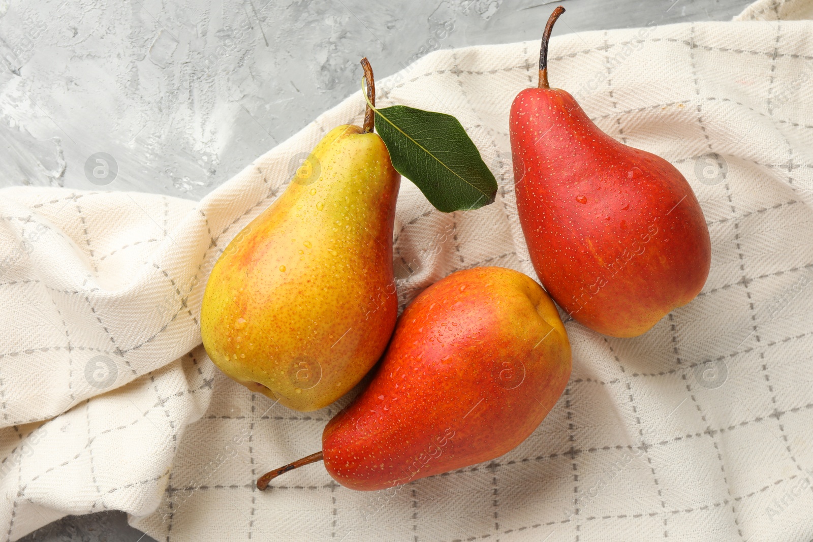 Photo of Ripe juicy pears on grey table, flat lay