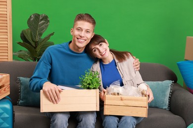 Happy couple with different stuff in new apartment. Housewarming party