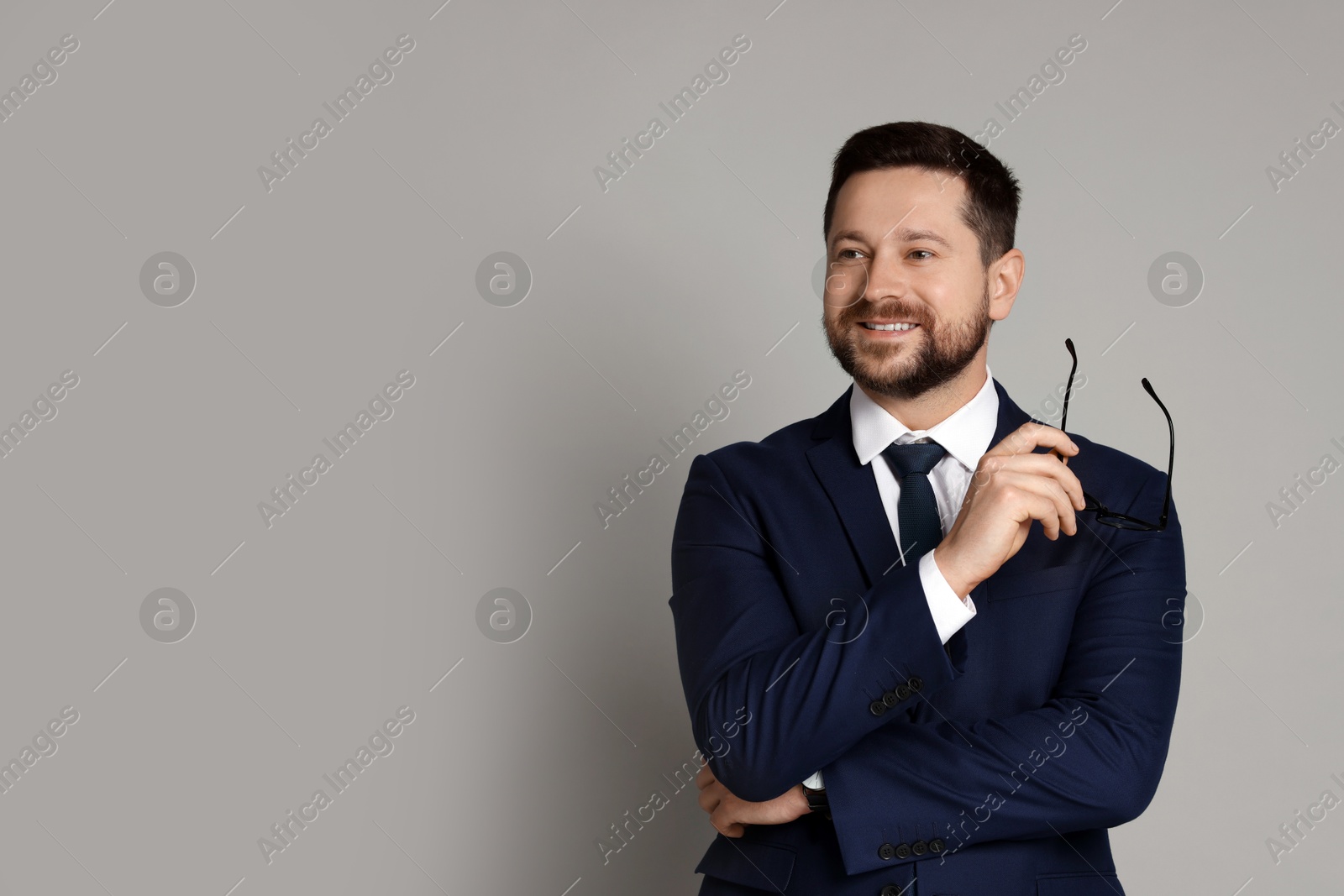 Photo of Portrait of banker with glasses on grey background, space for text