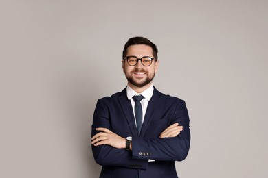 Portrait of banker in glasses on grey background