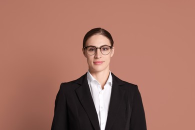 Photo of Portrait of banker in glasses on brown background