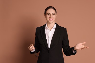 Photo of Portrait of banker with glasses on brown background