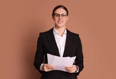 Photo of Portrait of banker with documents on brown background