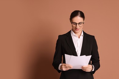 Photo of Portrait of banker with documents on brown background, space for text