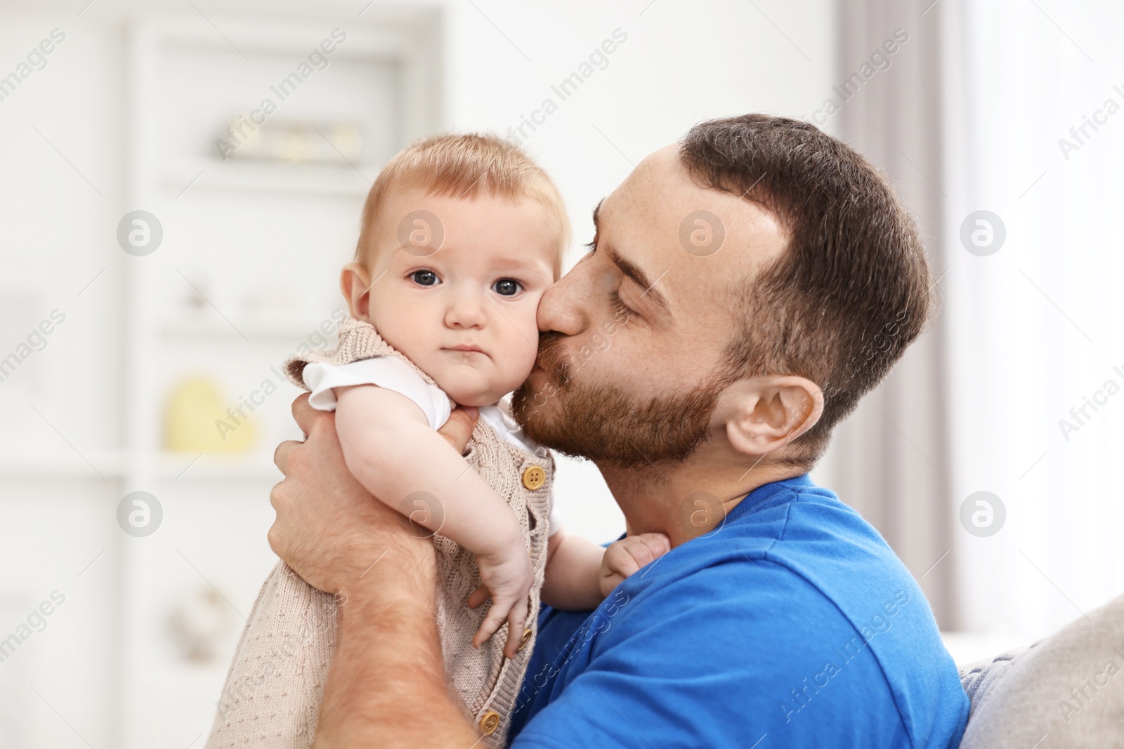 Photo of Dad with his cute little baby at home