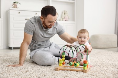 Photo of Dad playing with his cute baby at home