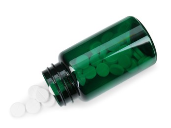 Photo of Medical bottle with antibiotic pills isolated on white, top view