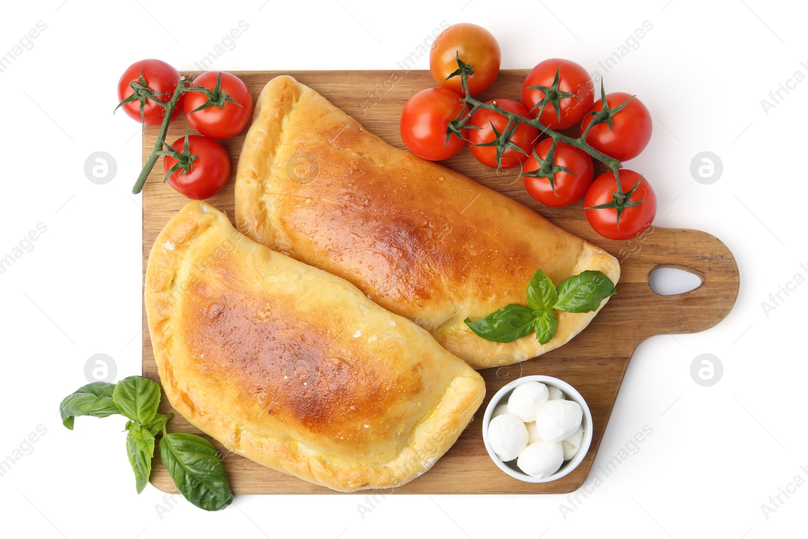 Photo of Tasty vegetarian calzones with basil, mozzarella cheese and tomatoes isolated on white, top view