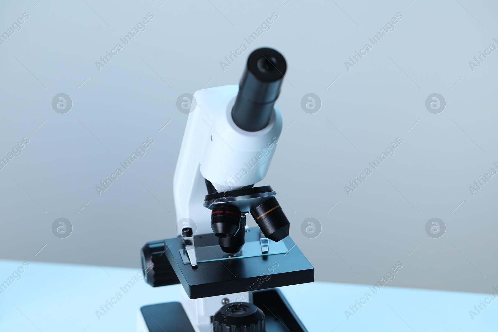 Photo of Science. Microscope with glass slide on blurred background, closeup