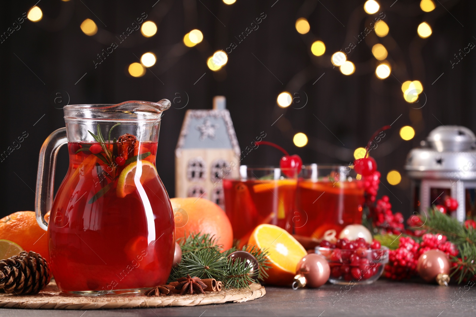 Photo of Tasty punch drink and Christmas decor on grey table