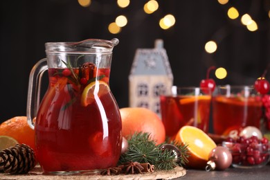 Photo of Tasty punch drink and Christmas decor on grey table