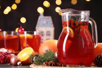 Photo of Tasty punch drink and Christmas decor on grey table