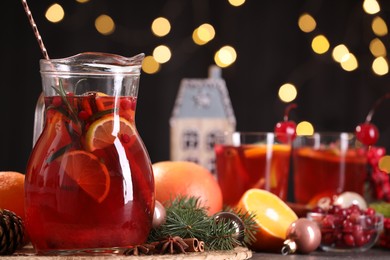 Photo of Tasty punch drink and Christmas decor on grey table