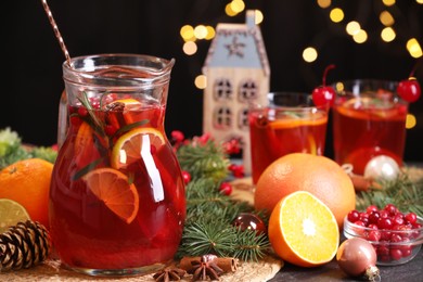 Photo of Tasty punch drink and Christmas decor on grey table