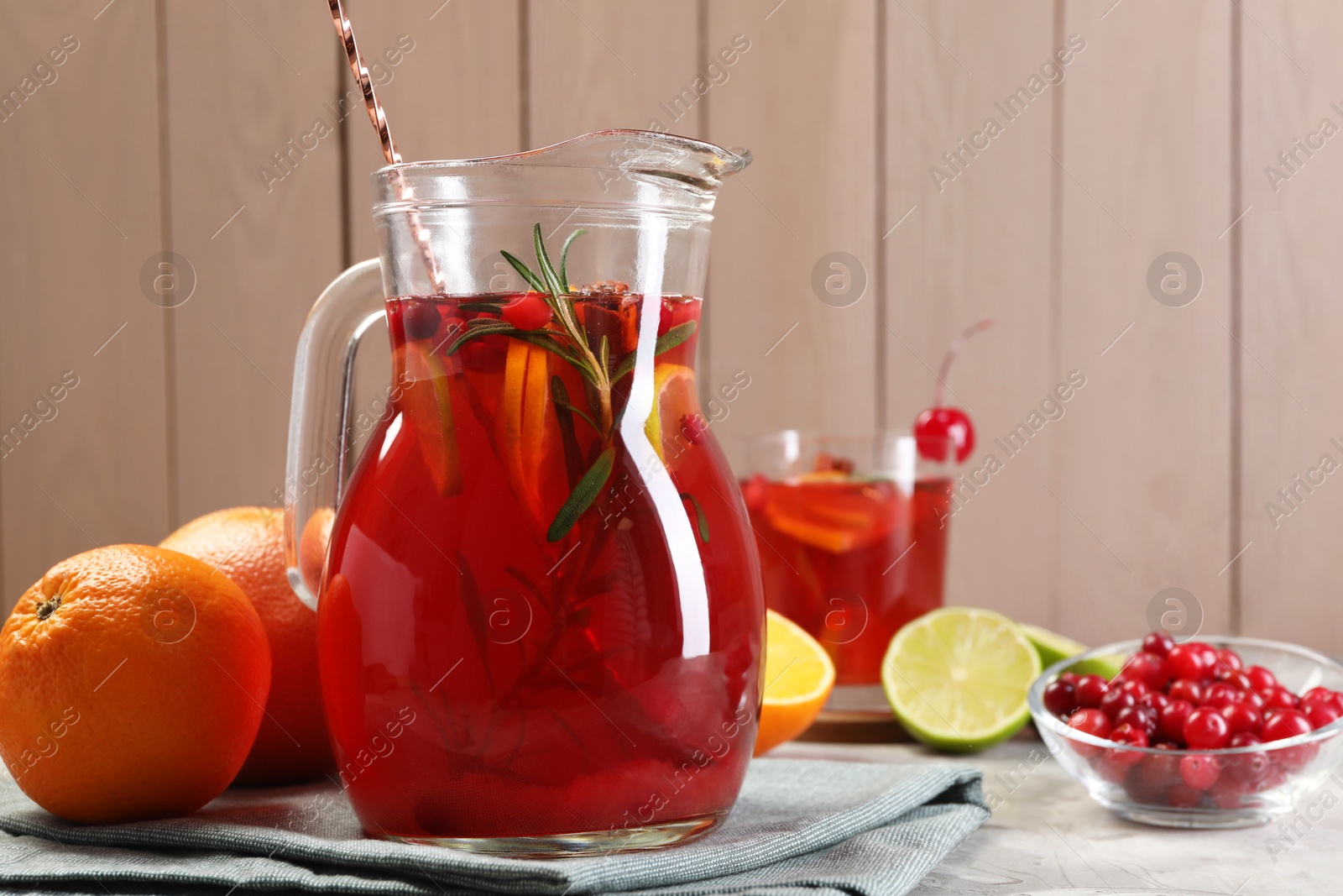 Photo of Tasty punch drink and ingredients on white table