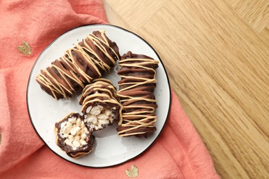 Delicious chocolate puffed rice bars on wooden table, top view. Space for text