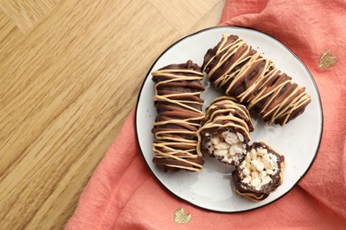 Photo of Delicious chocolate puffed rice bars on wooden table, top view. Space for text