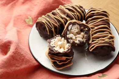 Photo of Delicious chocolate puffed rice bars on wooden table, closeup