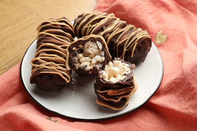 Photo of Delicious chocolate puffed rice bars on wooden table, closeup