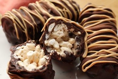 Photo of Delicious chocolate puffed rice bars on table, closeup