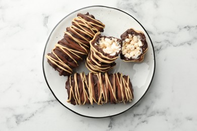 Photo of Delicious chocolate puffed rice bars on white marble table, top view