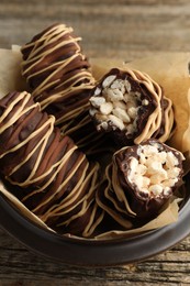 Delicious chocolate puffed rice bars on wooden table, closeup