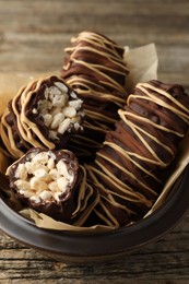 Delicious chocolate puffed rice bars on wooden table, closeup