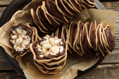 Photo of Delicious chocolate puffed rice bars on wooden table, top view