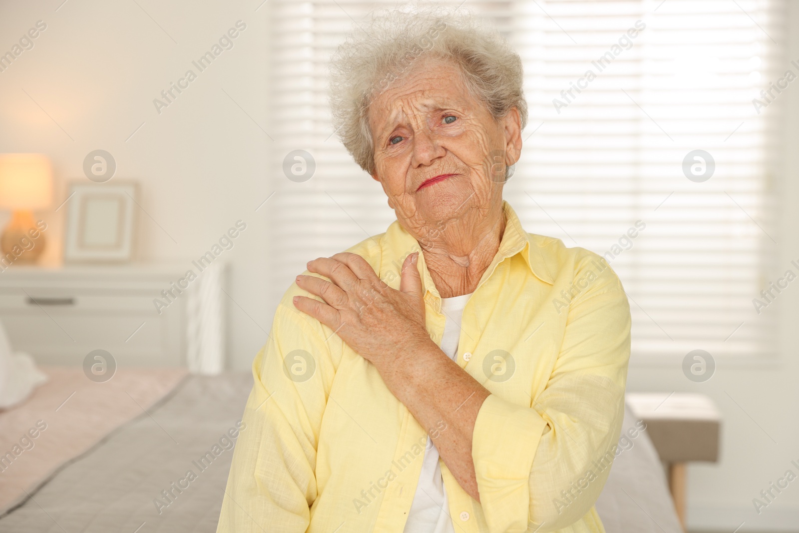 Photo of Portrait of sad senior woman at home