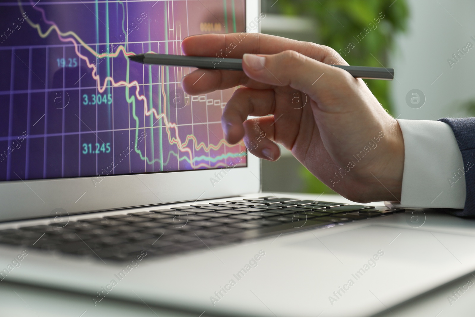 Photo of Businesswoman using laptop at table indoors, closeup. Modern technology