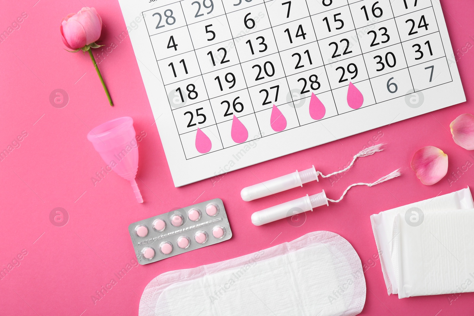 Photo of Flat lay composition with calendar and menstrual products on pink background