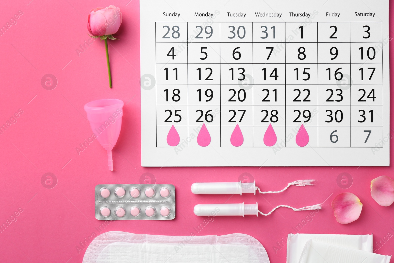 Photo of Flat lay composition with calendar and menstrual products on pink background