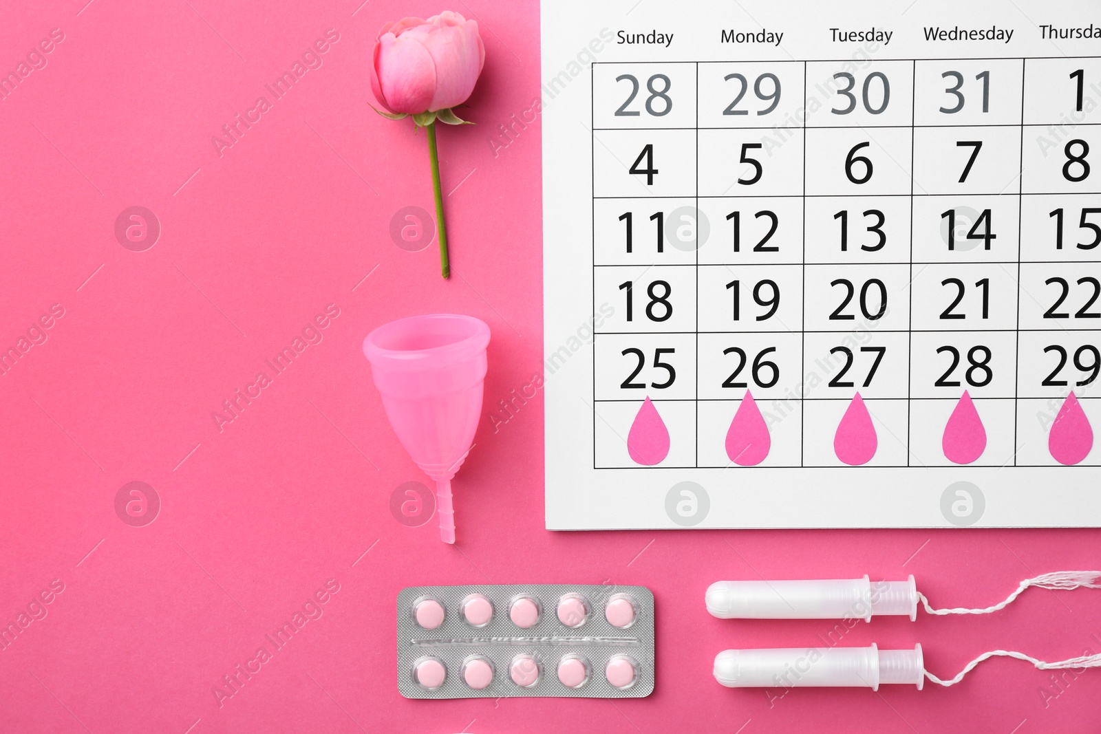 Photo of Flat lay composition with calendar and menstrual products on pink background