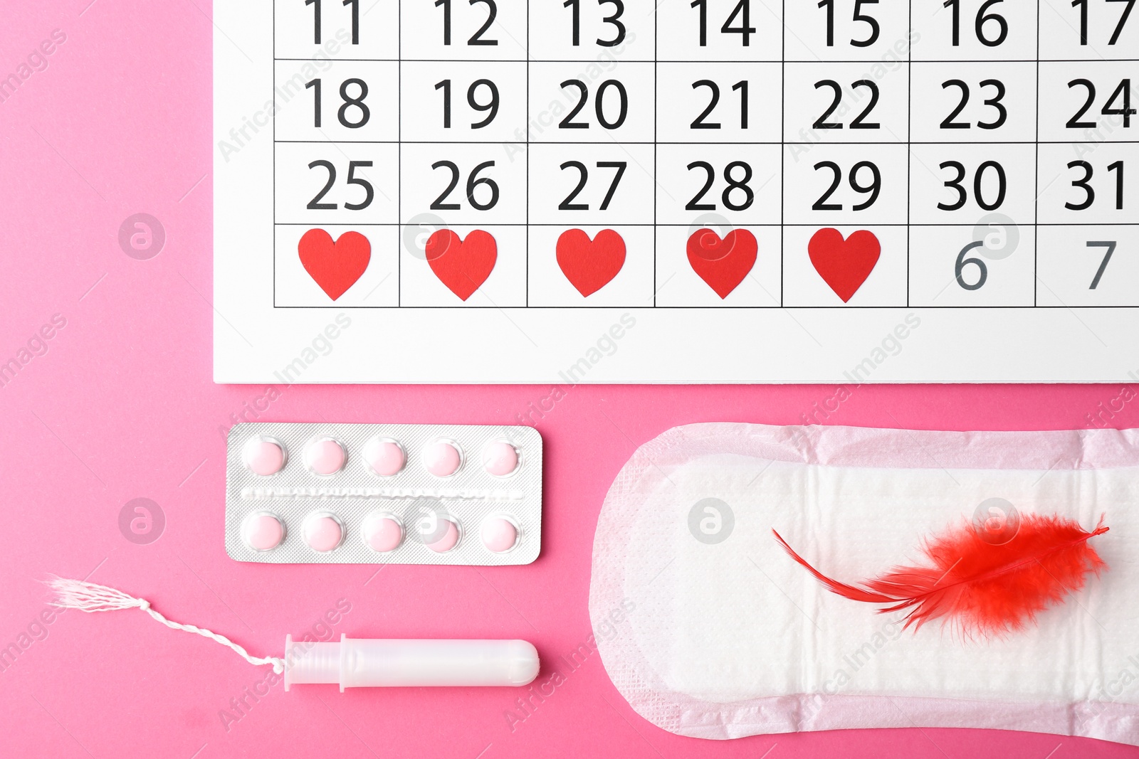 Photo of Flat lay composition with calendar and menstrual products on pink background