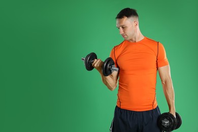 Photo of Man exercising with barbells on green background, space for text