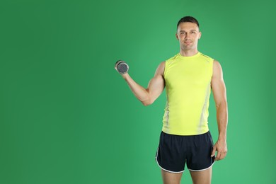 Photo of Man exercising with dumbbell on green background, space for text