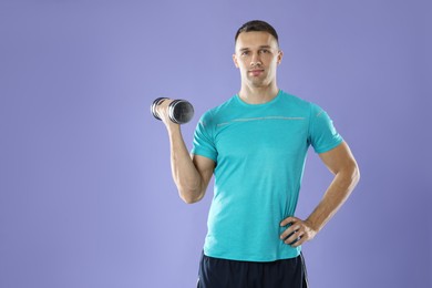 Photo of Man exercising with dumbbell on violet background, space for text