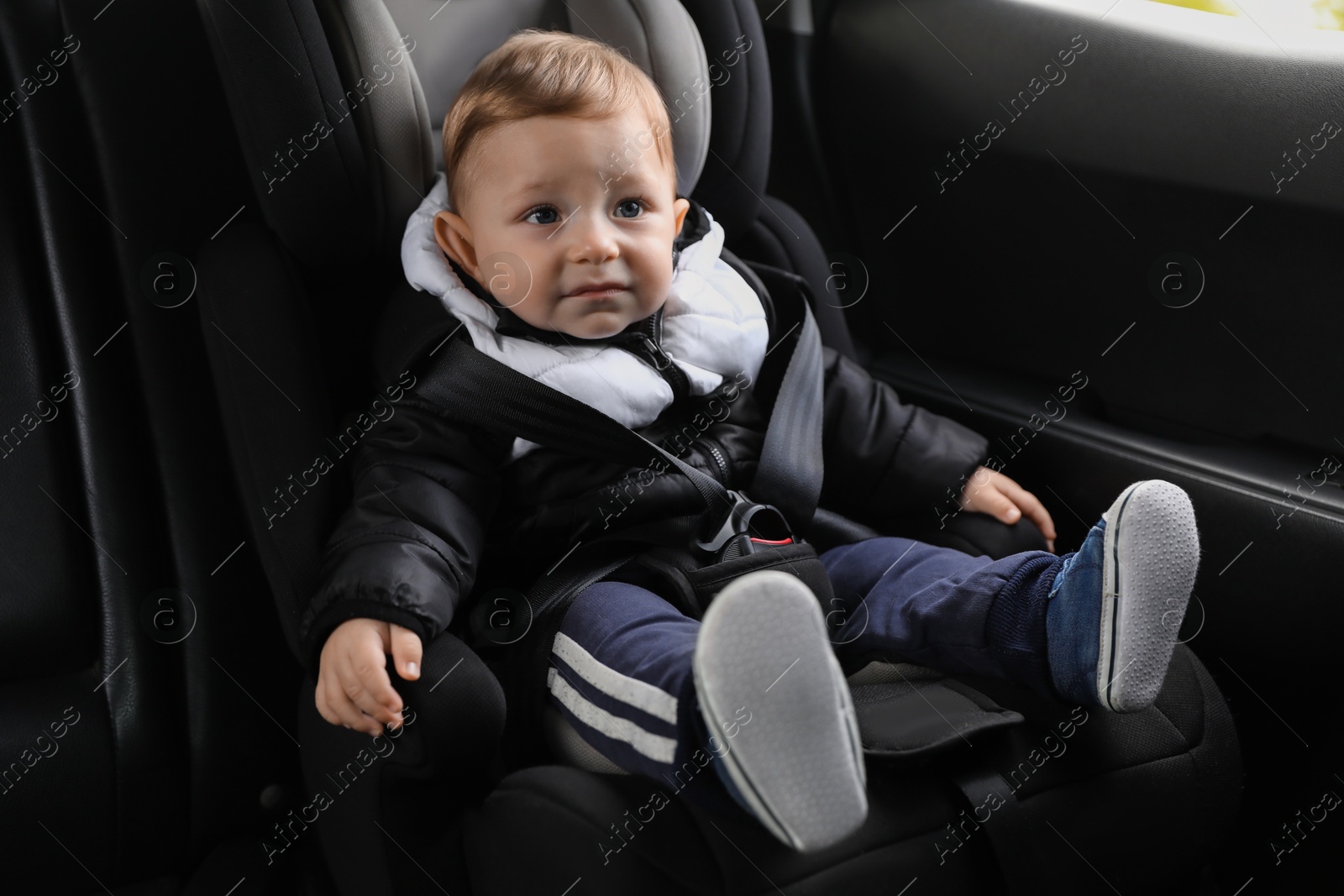 Photo of Cute little baby sitting in car seat