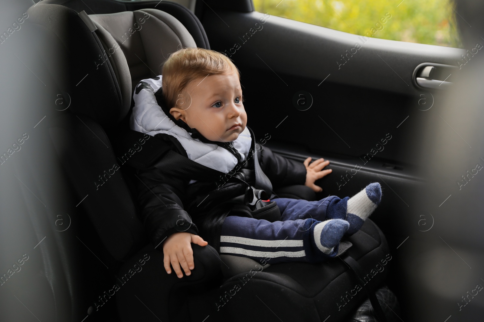 Photo of Cute little baby sitting in car seat