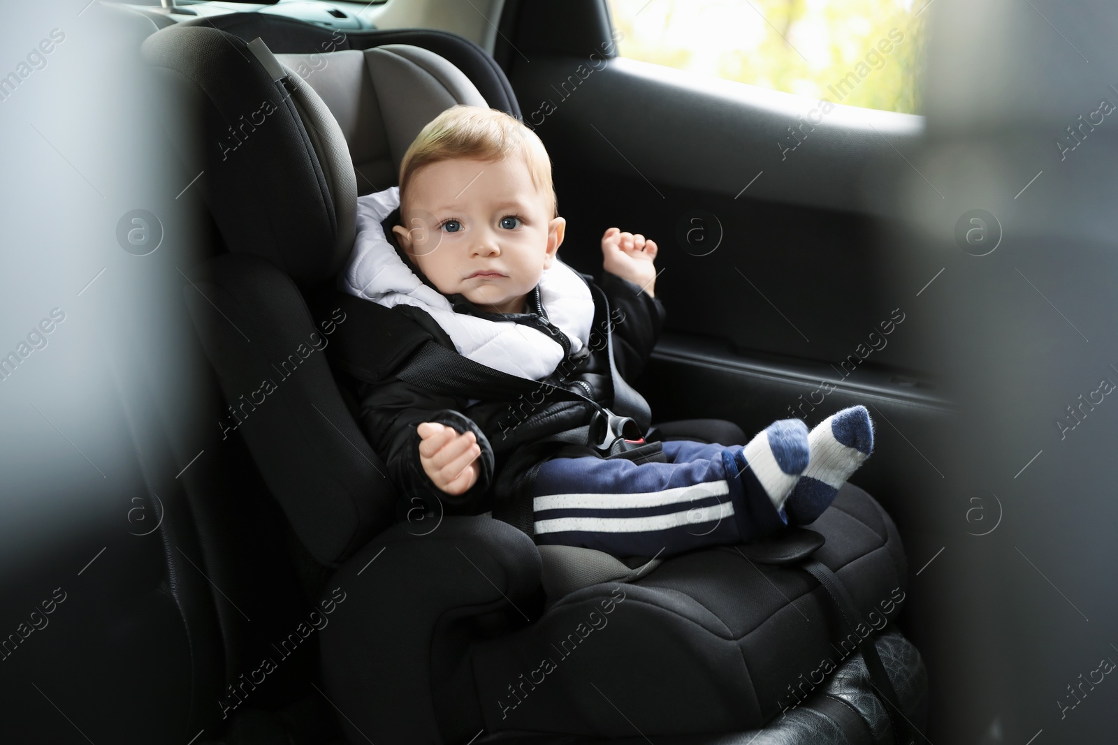 Photo of Cute little baby sitting in car seat